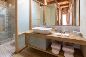 a bathroom with a sink and a shower at Polixeny's Suites in Chania