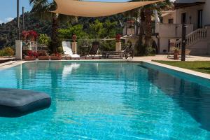 a swimming pool with blue water in a house at Tenuta Santa Tecla in Acireale