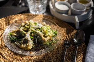 a plate of food with meat and vegetables on a table at Finca Serena Mallorca, Small Luxury Hotels in Montuiri