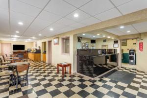 a restaurant with a checkered floor and tables and chairs at Econo Lodge Morgantown in Morgantown