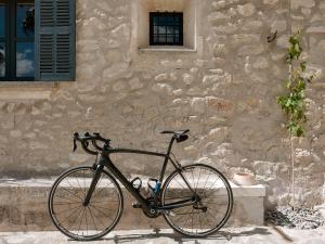 
a bicycle parked in front of a stone wall at Finca Serena, Small Luxury Hotels in Montuiri
