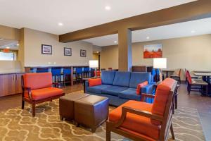 a waiting room with a blue couch and chairs at Comfort Inn & Suites Page at Lake Powell in Page