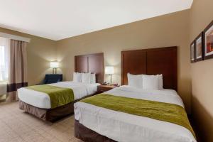 a hotel room with two beds with green sheets at Comfort Inn & Suites Page at Lake Powell in Page