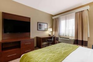 a hotel room with a bed and a flat screen tv at Comfort Inn & Suites Page at Lake Powell in Page