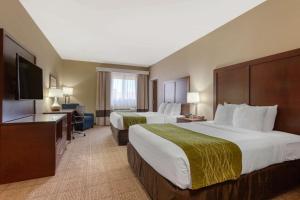 a hotel room with two beds and a flat screen tv at Comfort Inn & Suites Page at Lake Powell in Page