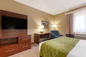 a hotel room with a bed and a flat screen tv at Comfort Inn & Suites Page at Lake Powell in Page
