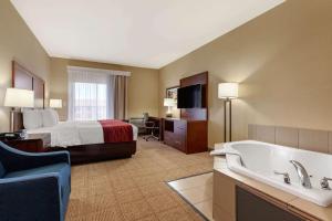 a hotel room with a bed and a bath tub at Comfort Inn & Suites Page at Lake Powell in Page