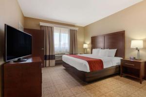 a hotel room with a bed and a flat screen tv at Comfort Inn & Suites Page at Lake Powell in Page