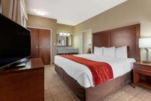 a hotel room with a large bed and a flat screen tv at Comfort Inn & Suites Page at Lake Powell in Page