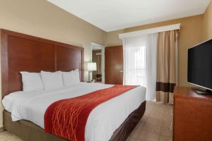 a hotel room with a large bed and a flat screen tv at Comfort Inn & Suites Page at Lake Powell in Page