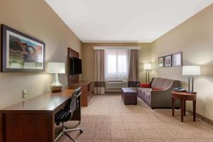 a hotel room with a couch and a desk at Comfort Inn & Suites Page at Lake Powell in Page
