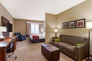 a hotel room with a couch and a bed at Comfort Inn & Suites Page at Lake Powell in Page