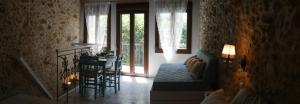 a living room with a couch and a table and windows at Agalide in Kissamos