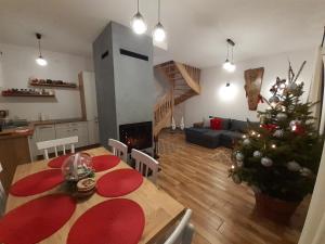 a living room with a table and a christmas tree at Brzozowy Zagajnik in Bereżnica Wyżna