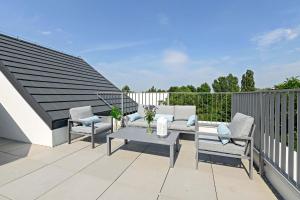 a patio with chairs and a table on a balcony at Equus Sopot Apartments in Sopot