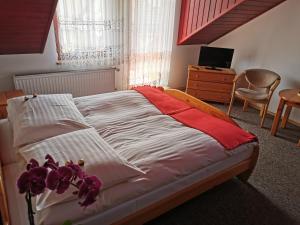 a bedroom with a bed with purple flowers on it at Dom pod Tujami in Krakow