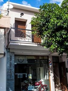 a store with a red bike in front of a building at Agalide in Kissamos