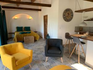 a living room with a bed and a yellow chair at Casa Valinco in Propriano