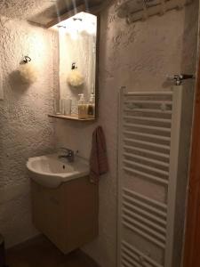 a bathroom with a sink and a mirror at Wildherb House in Agriovótanon