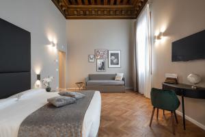 a bedroom with a large bed and a couch at Hotel Palazzo Martinelli Dolfin in Venice +37 photos