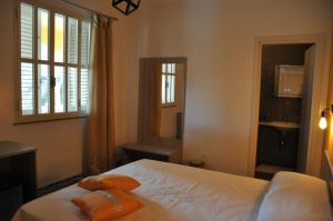 a bedroom with a bed with two pillows on it at La Fenice in Lampedusa