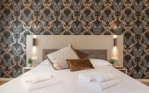 a bedroom with a large white bed with two pillows at Hotel Grifoni in Venice