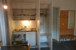 a small kitchen with a sink and a table at Studio in Architeken - Villa in Theaternähe in Meiningen