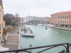 a river with boats on it and a bridge at Grand Canal Suite by Wonderful Italy in Venice +82 photos
