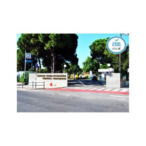 a street with a sign on the side of a road at Parque de Campismo Orbitur Costa de Caparica in Costa da Caparica