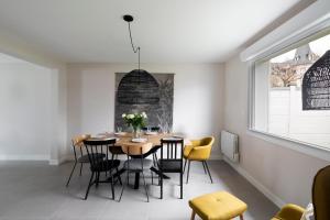 uma sala de jantar com mesa e cadeiras em Villa du Marché by Cocoonr em Dinard