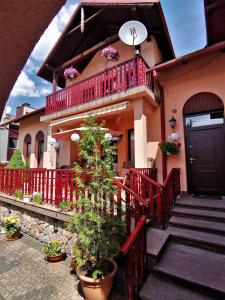 a house with a red railing and a balcony at Dom pod Tujami in Krakow