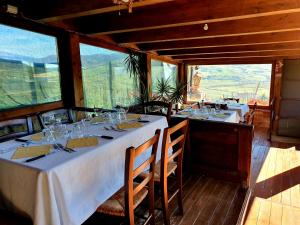 un comedor con 2 mesas con copas de vino en Agriturismo Leanza "La Baita", en Cesarò