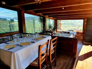 a dining room with two tables with wine glasses at Agriturismo Leanza "La Baita" in Cesarò