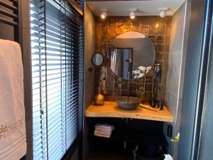 a bathroom with a sink and a mirror at Hotel-Restaurant Unicum Elzenhagen in Poeldijk +24 photos