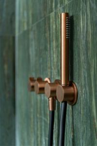 a wooden holder with a comb and two cords at Aristide Hotel - Small Luxury Hotels of the World in Ermoupoli +37 photos