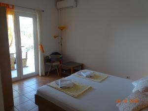 1 dormitorio con 2 camas y puerta corredera de cristal en Apartments Antea & Magdalena en Pirovac