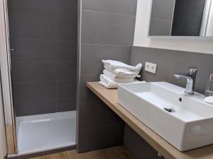 a bathroom with a sink and a shower at Beachtime Suite in Zandvoort