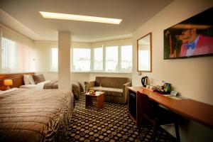 a hotel room with a bed and a couch at The North Trabzon in Trabzon