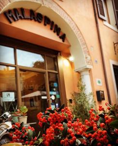 a building with a sign on the side of it at Corte Malaspina in Castelnuovo del Garda