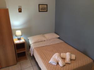 a small bedroom with a bed with towels on it at The Pirate's Mansion in Nafplio +13 photos