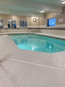 a large swimming pool in a building with a clock on the wall at Best Western Brigham City Inn & Suites in Brigham City
