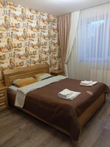 - une chambre avec un lit et des serviettes dans l'établissement однокімнатна квартира в новобудові по Мельника, à Rivne