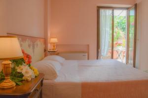 a bedroom with a bed with a table with a lamp at Velia Mare in Numana