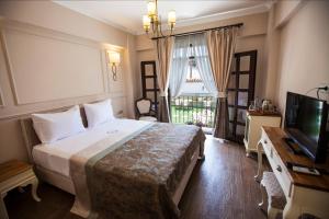 A bed or beds in a room at Livia Garden Hotel