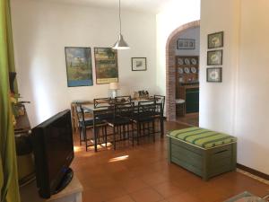 a living room with a table and chairs and a television at Vigna Licia in Pomezia