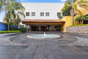 a fountain in front of a building at Hotel Rancho San Diego Grand Spa Resort in Ixtapan de la Sal