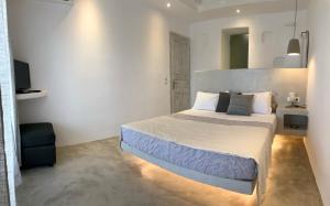 a bedroom with a large bed in a room at Mykonos Village in Ano Mera