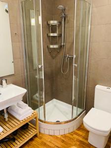 a bathroom with a shower with a toilet and a sink at Super Balmes Guest House in Barcelona