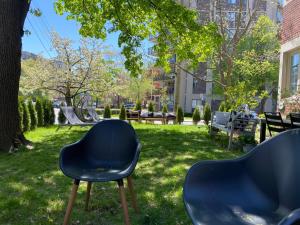 two chairs sitting in the grass in a park at The Jane Toronto in Toronto