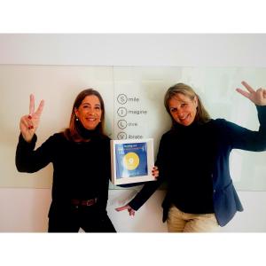 two women holding up a box with an egg on it at Aparthotel Silver in Barcelona